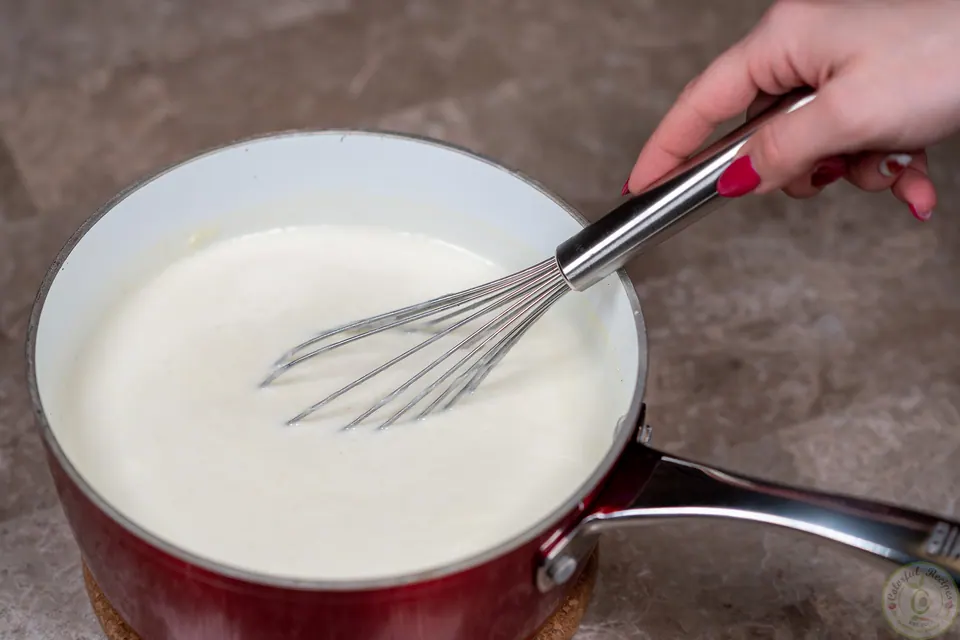 Whisking the milk ice cream booza mixture in a saucepan