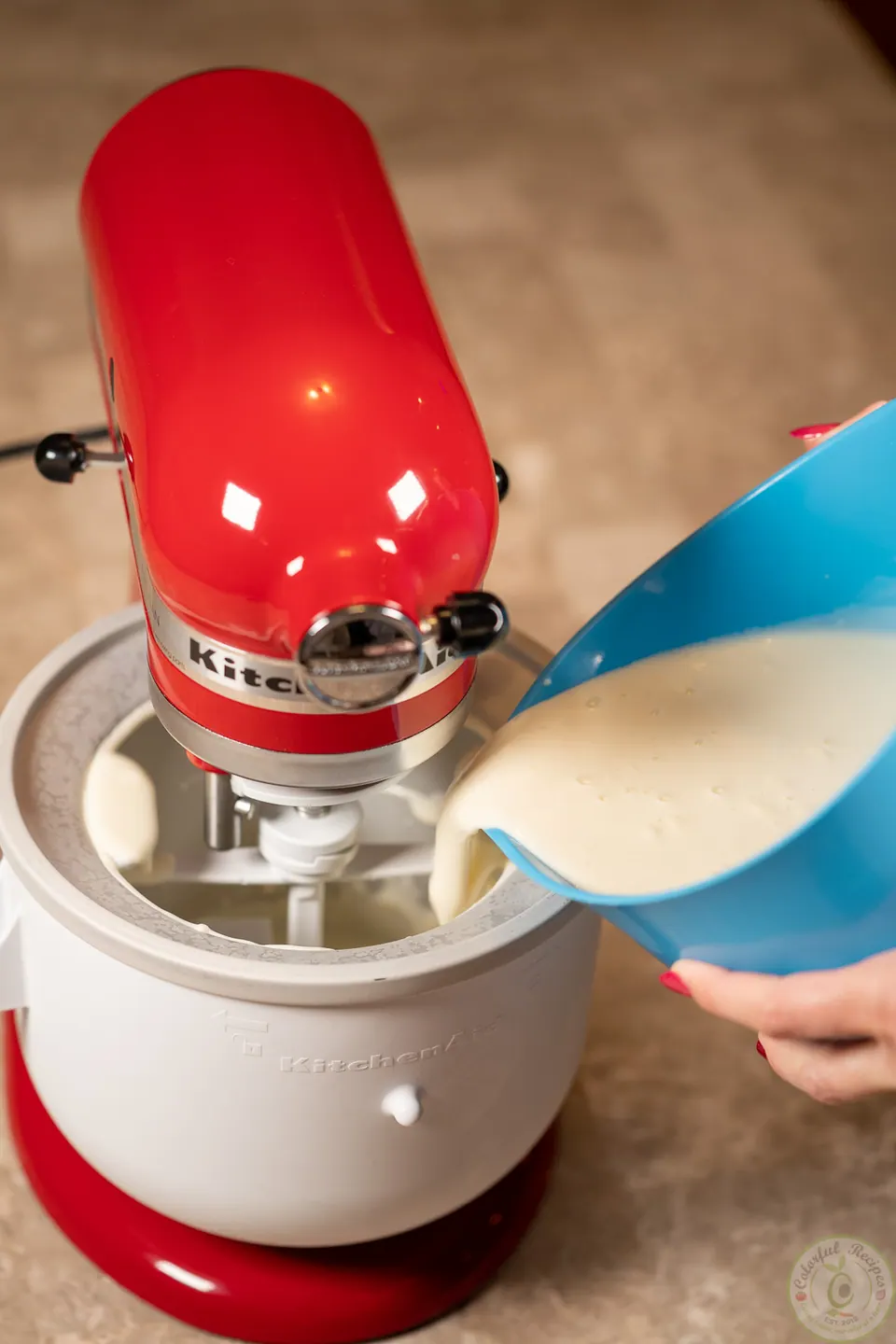 Pouring booza mixture into an ice cream maker