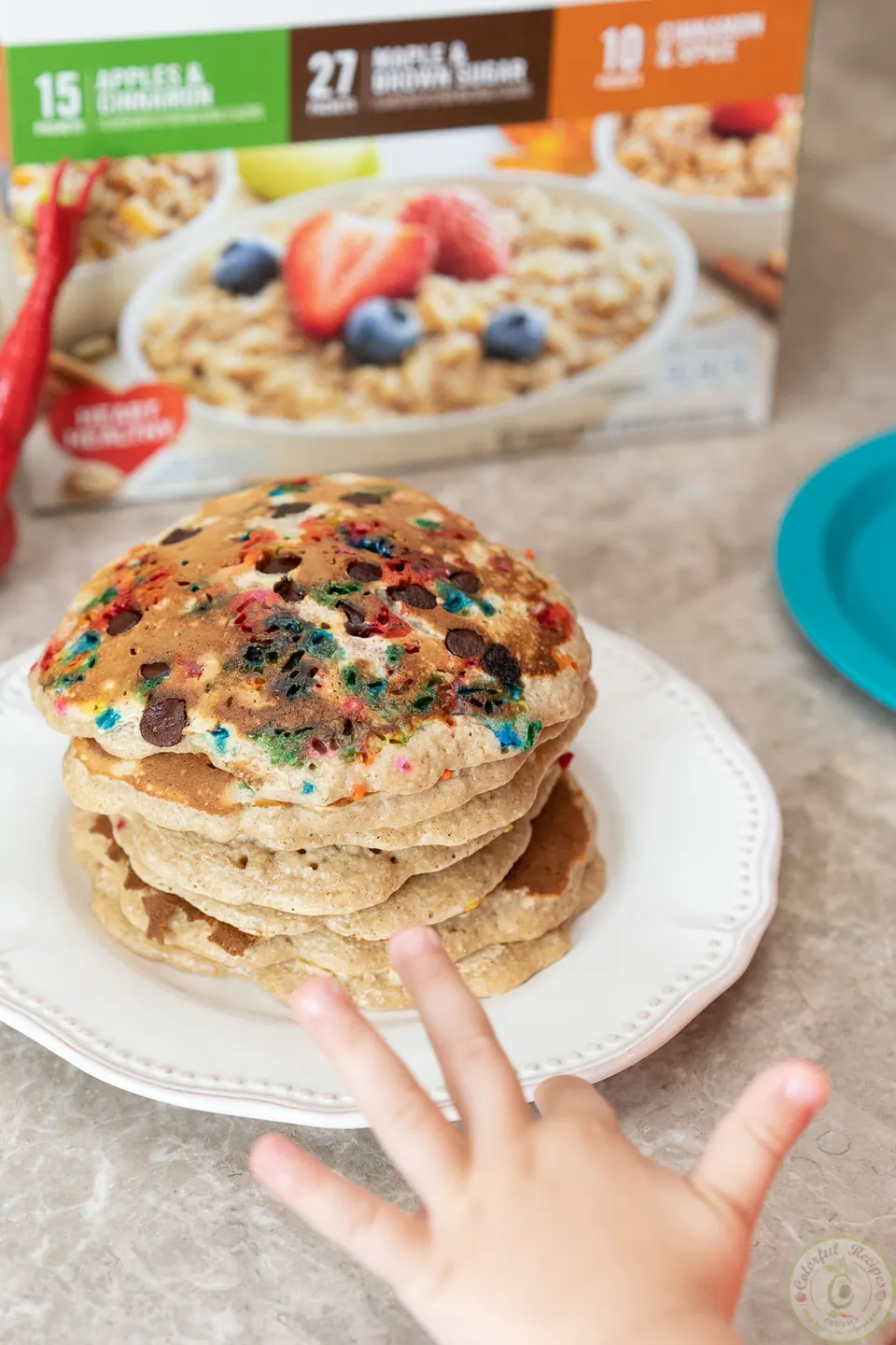 Little hand reaching for a stack of easy oatmeal pancakes