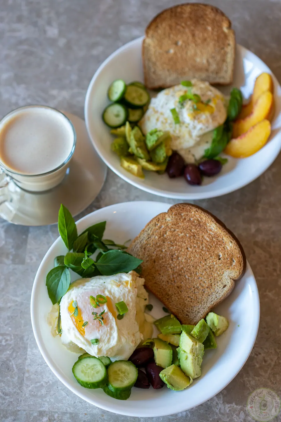 Two egg whites breakfast power bowls with toast and fruit on the table