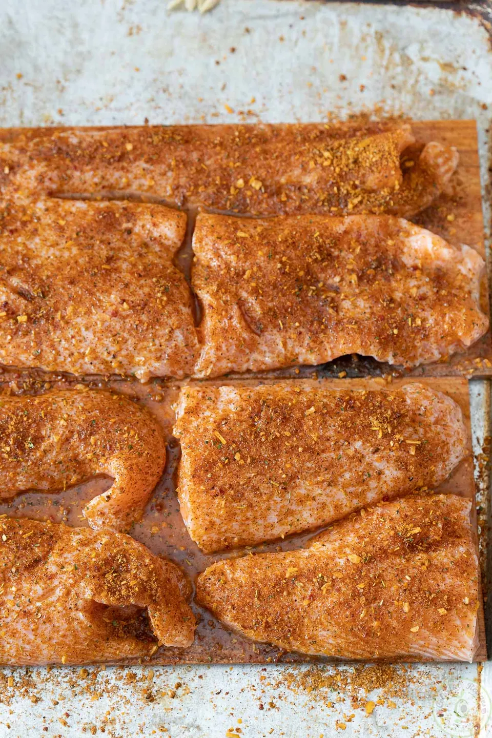 Salmon on cedar planks coated with a thin layer of seasoning