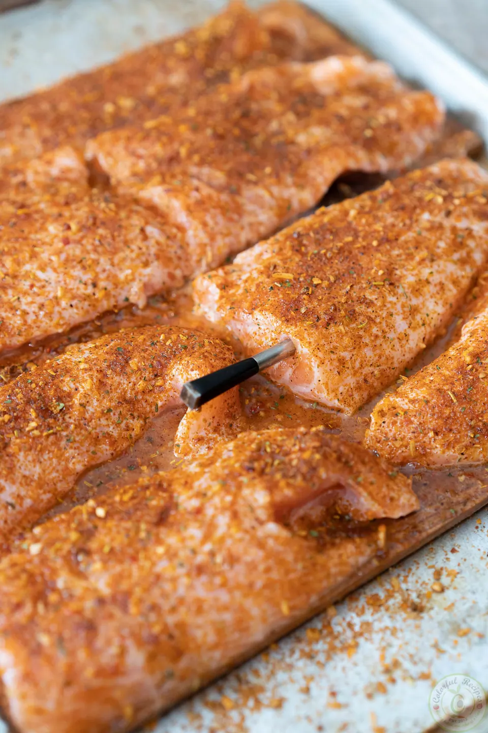 MEATER probe inserted into seasoned salmon on a cedar plank