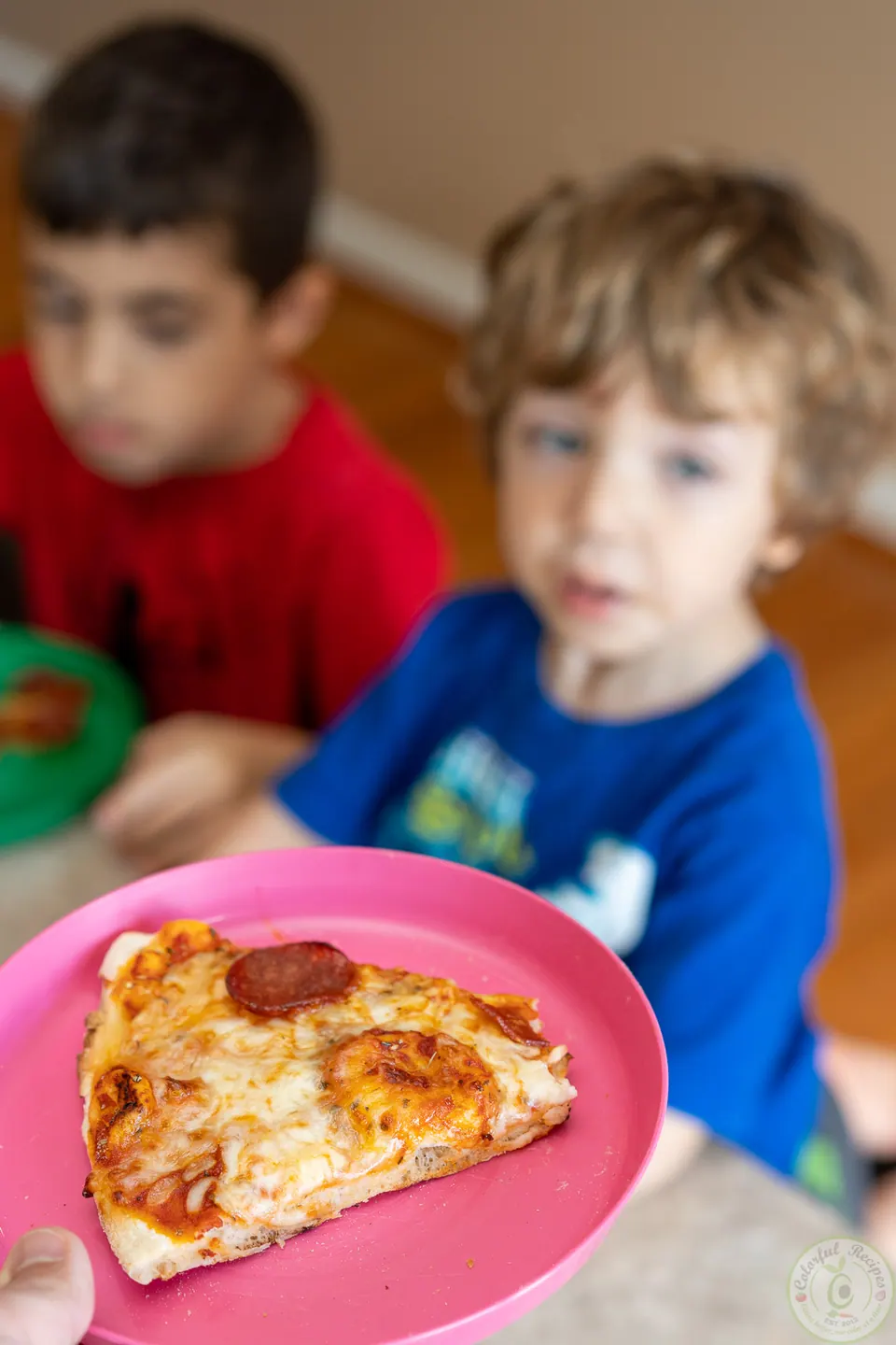 Kids enjoying a slice of classic pepperoni pizza