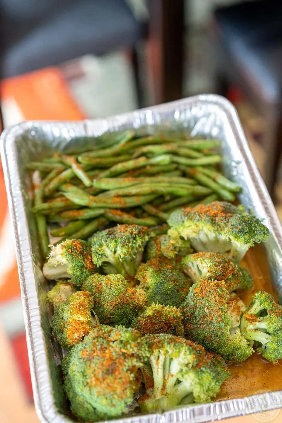 Green beans and broccoli in a foil tray, ready to steam on the grill