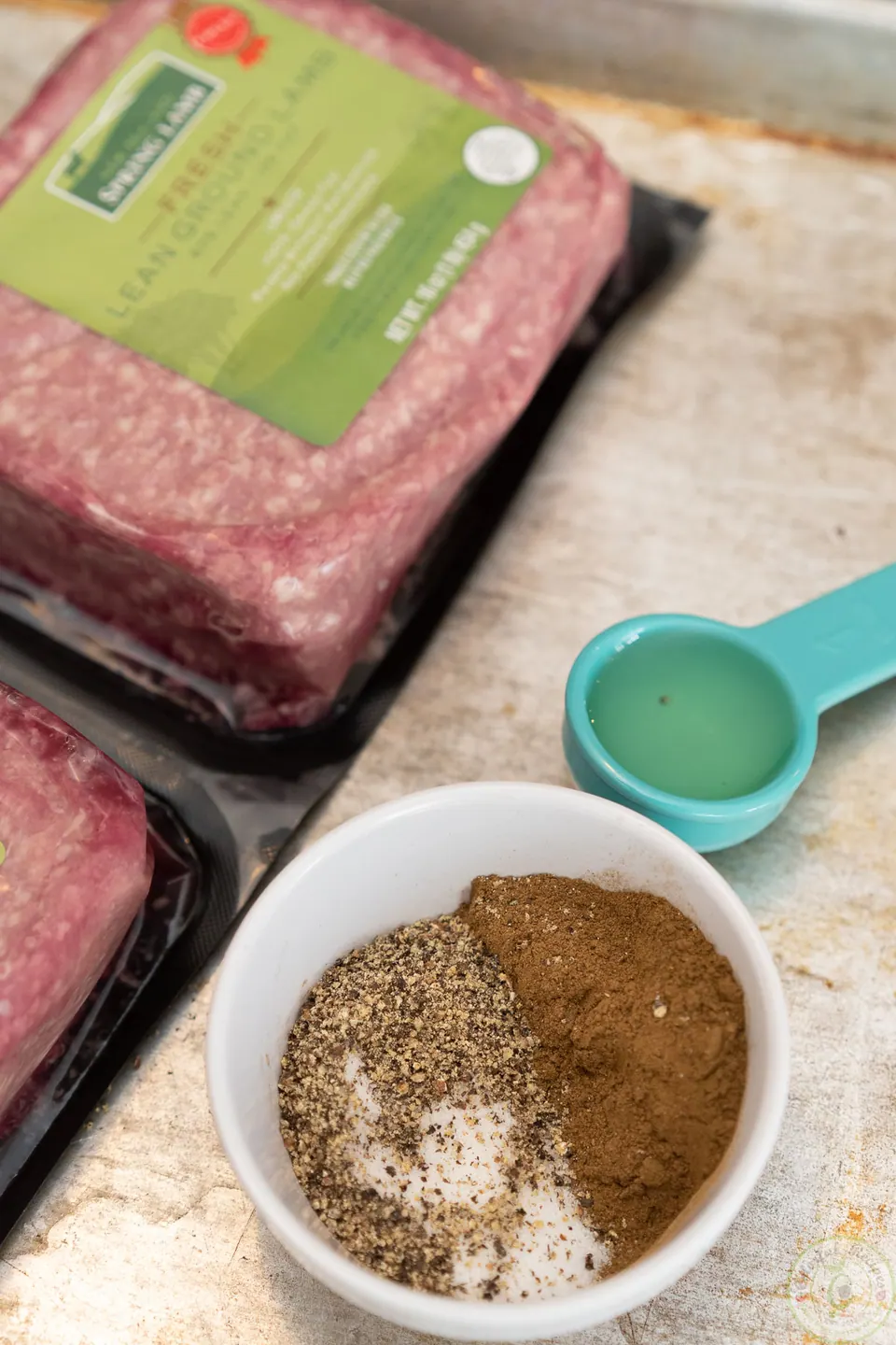 Ground lamb packages and a bowl of spices for kafta