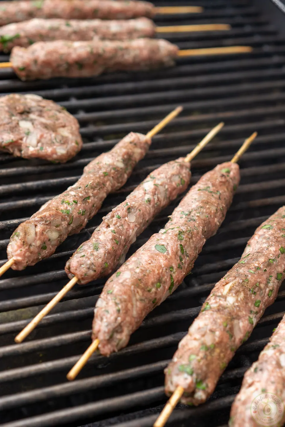Lamb kafta kabob skewers cooking on a hot grill