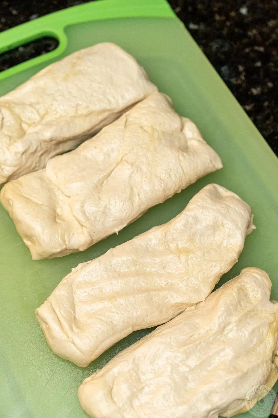 Pizza dough divided into 4 equal pieces