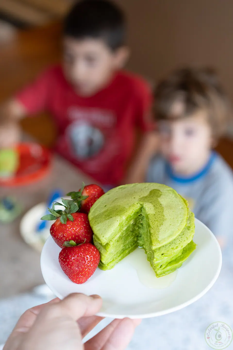 Healthy green pancakes with spinach and fresh berries