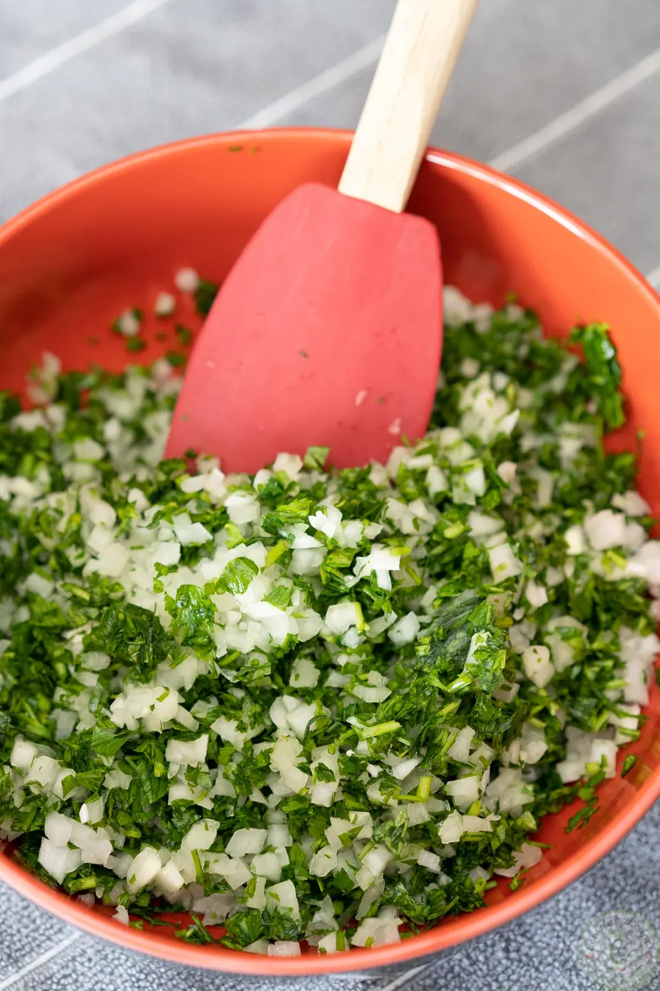 Finely chopped parsley and onions in a bowl for Lebanese kafta