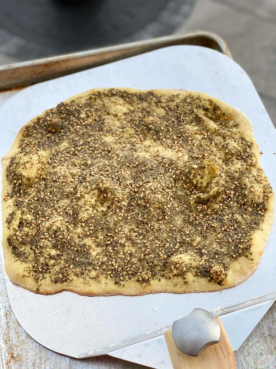 Freshly baked Lebanese zaatar mankousheh on a pizza peel