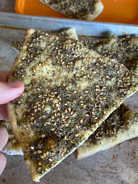 Slices of Lebanese mankousheh topped with zaatar thyme and sesame seeds