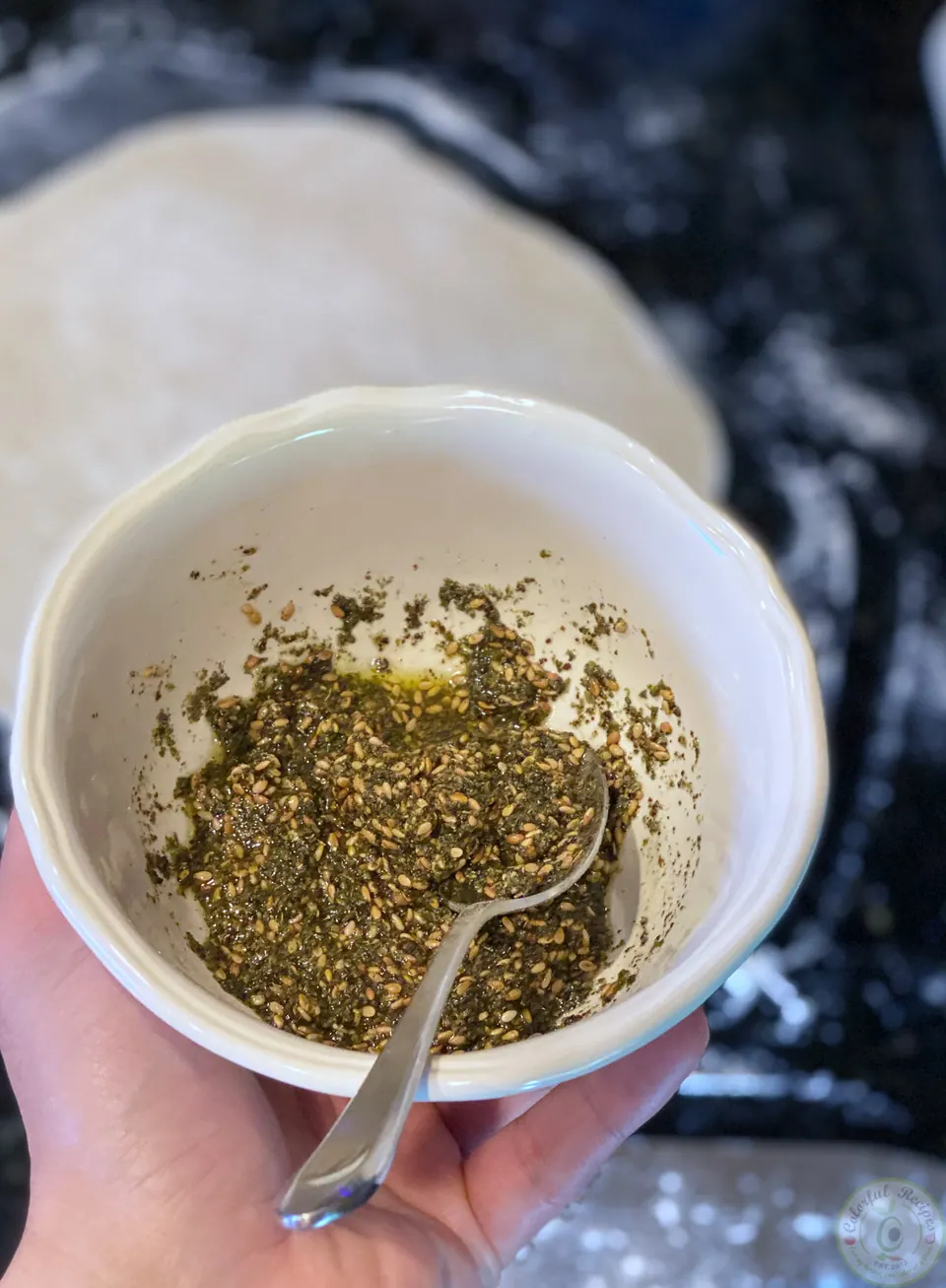 Bowl of zaatar thyme blend mixed with olive oil for mankousheh
