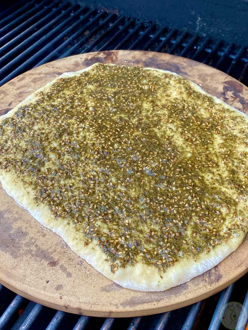 Zaatar mankousheh on a pizza stone on the grill
