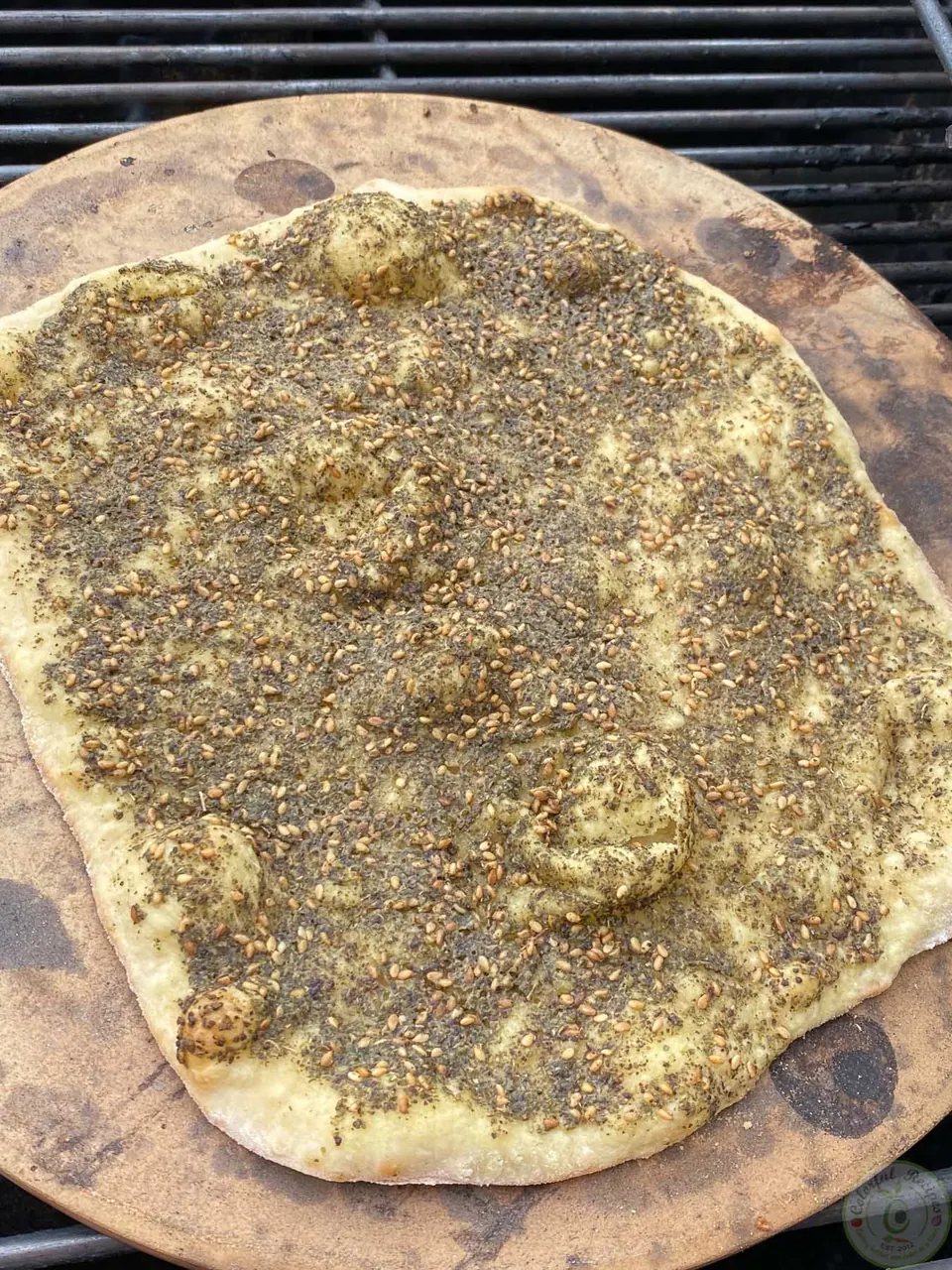 Zaatar mankousheh baking on a pizza stone
