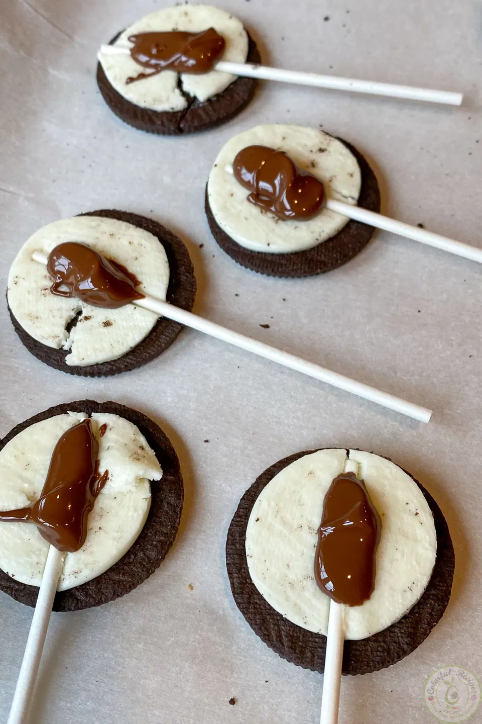 Melted chocolate added as glue over the sticks for Oreo pops