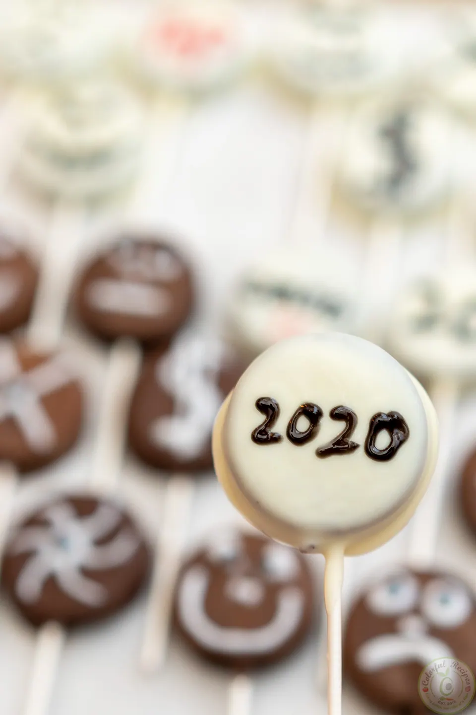 White chocolate Halloween Oreo pop decorated with 2020 in icing