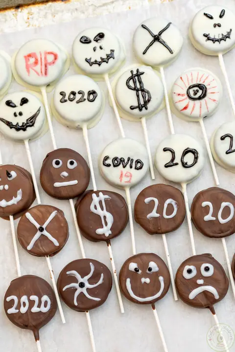 Halloween Oreo pops dipped in white and dark chocolate and decorated with spooky faces