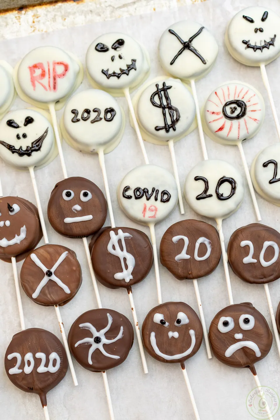 Halloween Oreo pops dipped in white and dark chocolate and decorated with spooky faces