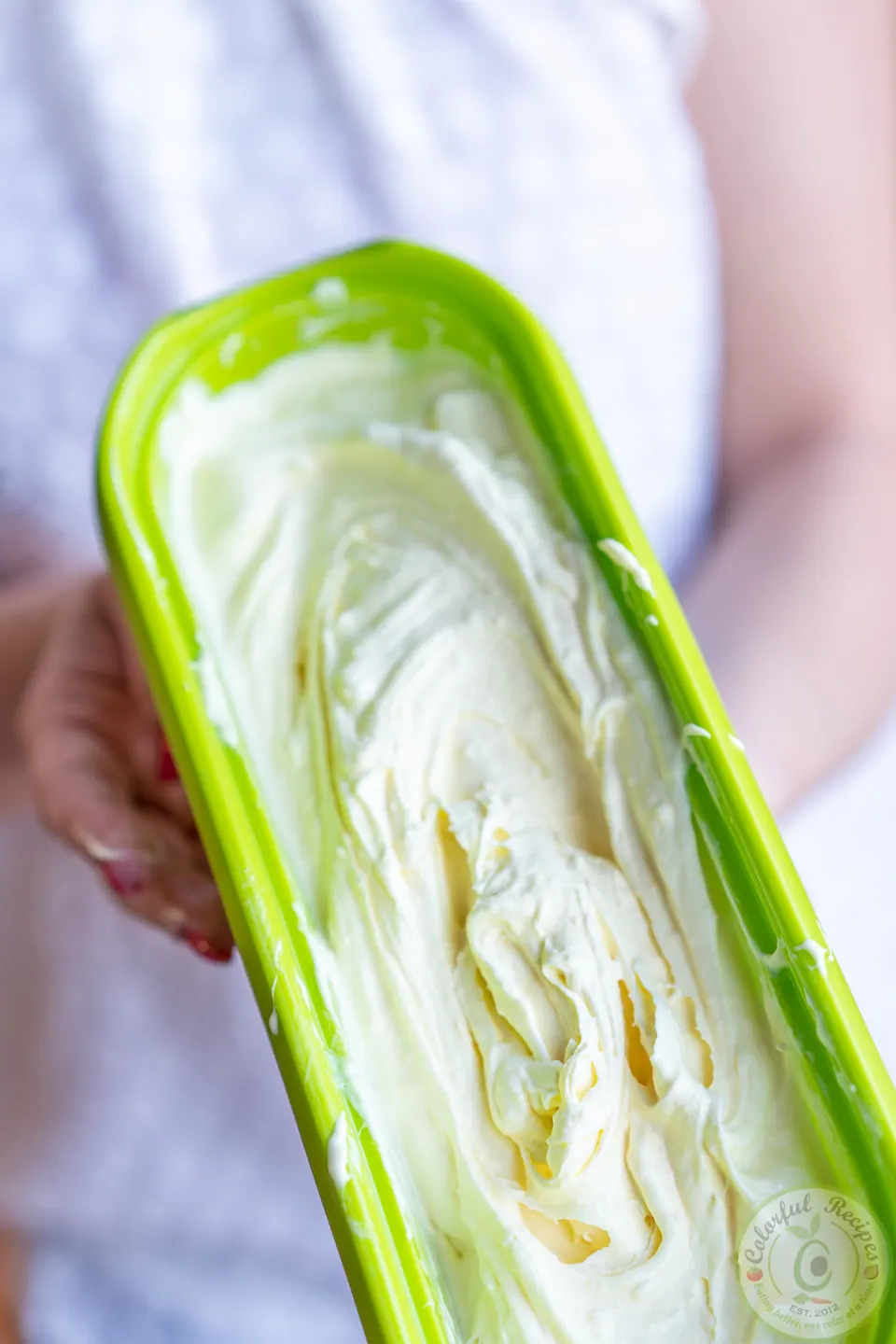 Homemade lemon ice cream in a freezer tub