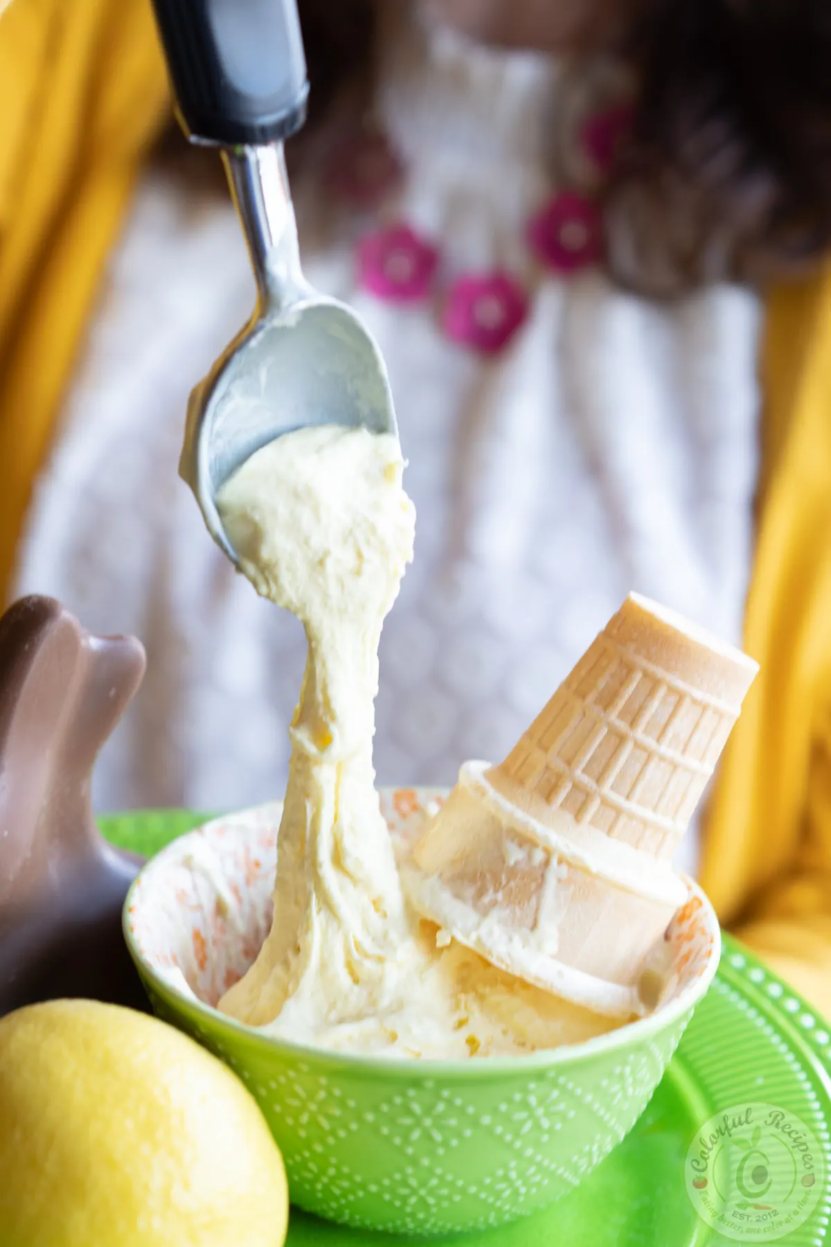 Scoops of zesty fluffy stretchy lemon ice cream in a bowl