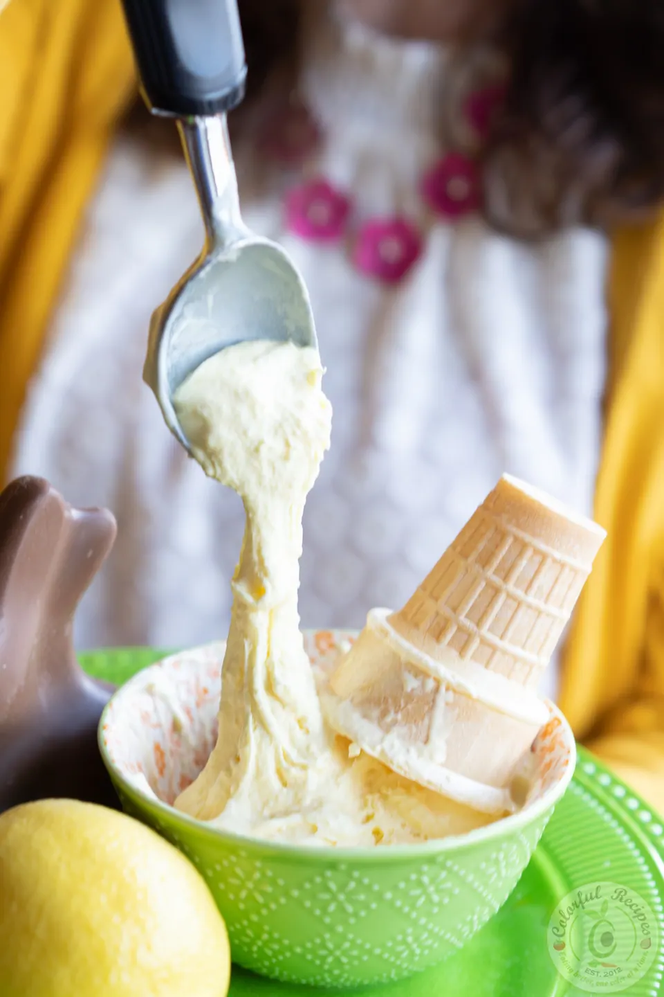 Scoops of zesty fluffy stretchy lemon ice cream in a bowl