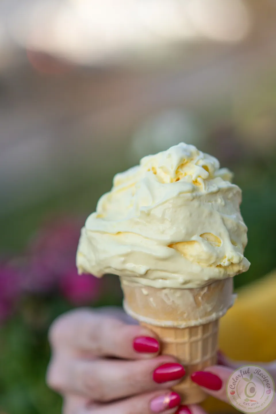 Bowl of zesty fluffy stretchy lemon ice cream with fresh lemons