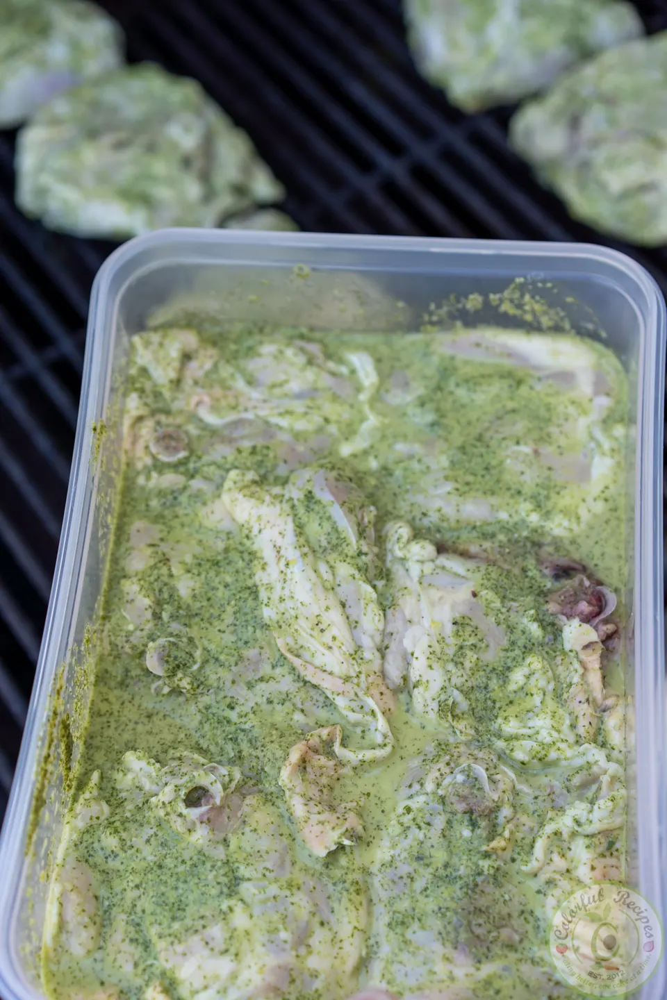 Chicken thighs soaking in a green cilantro lemon garlic marinade