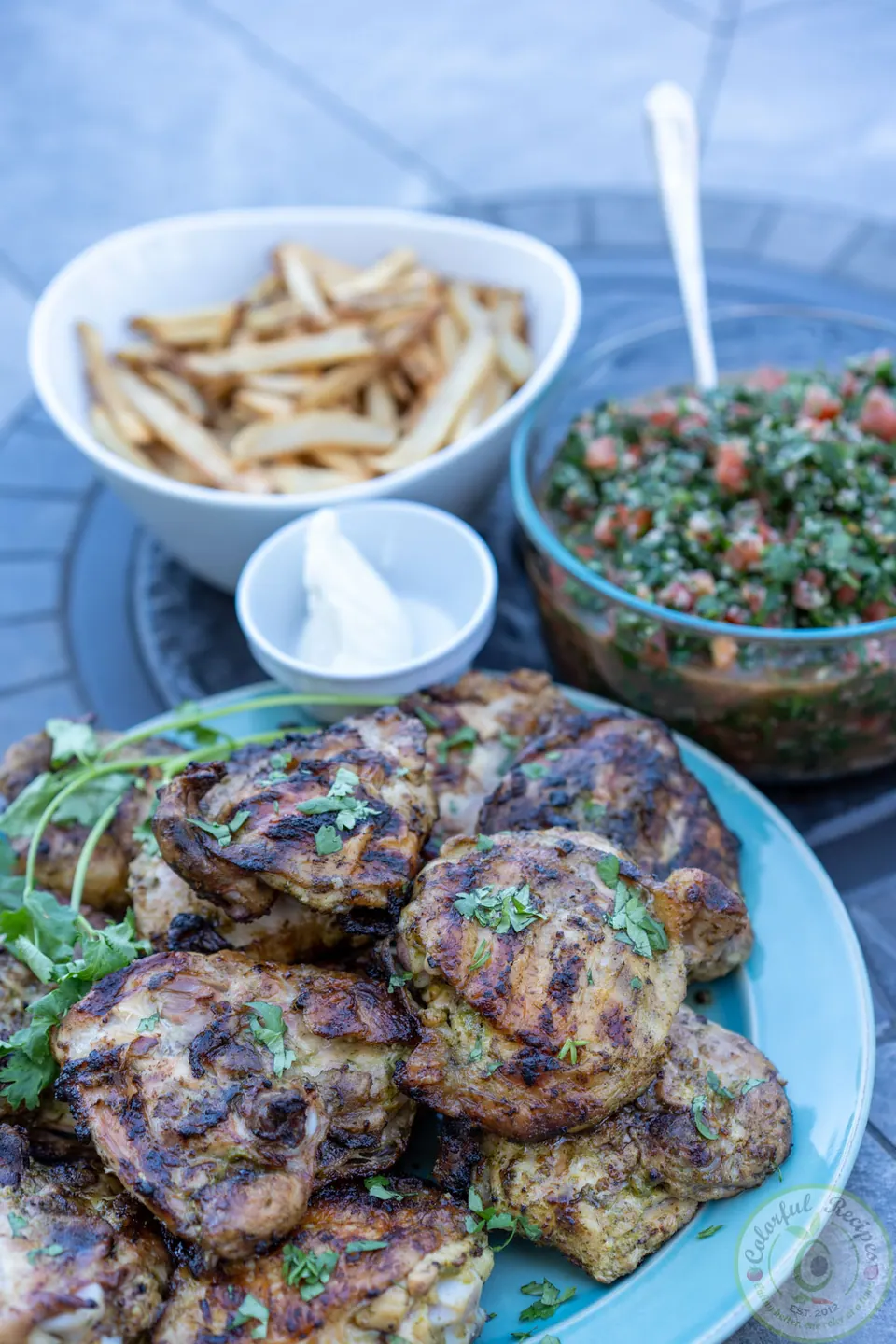 Plate of crispy cilantro lemon garlic grilled chicken thighs