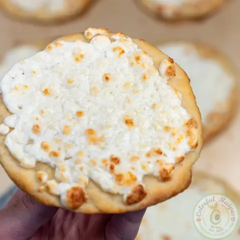 Close-up of a small cheese manakish with golden melted Akkawi cheese