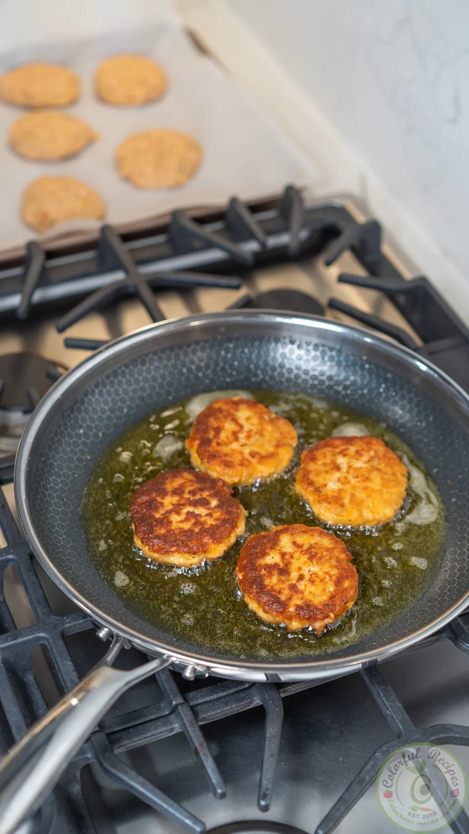 Golden brown salmon patties in the pan