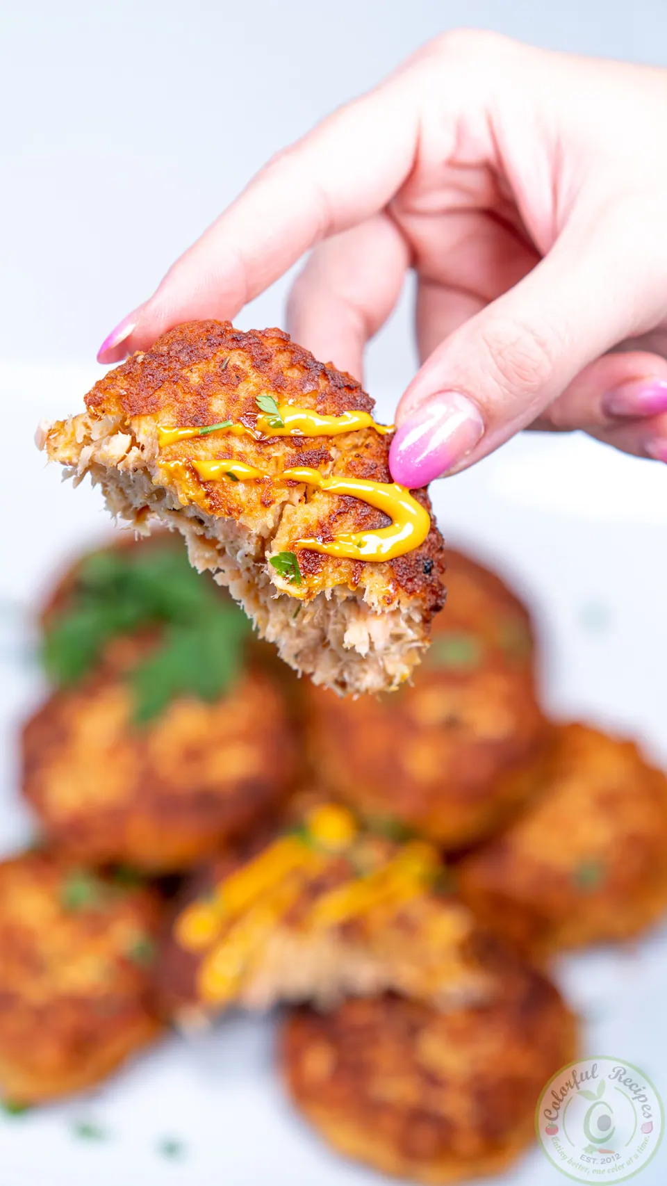 Bitten salmon patty with sriracha mayo