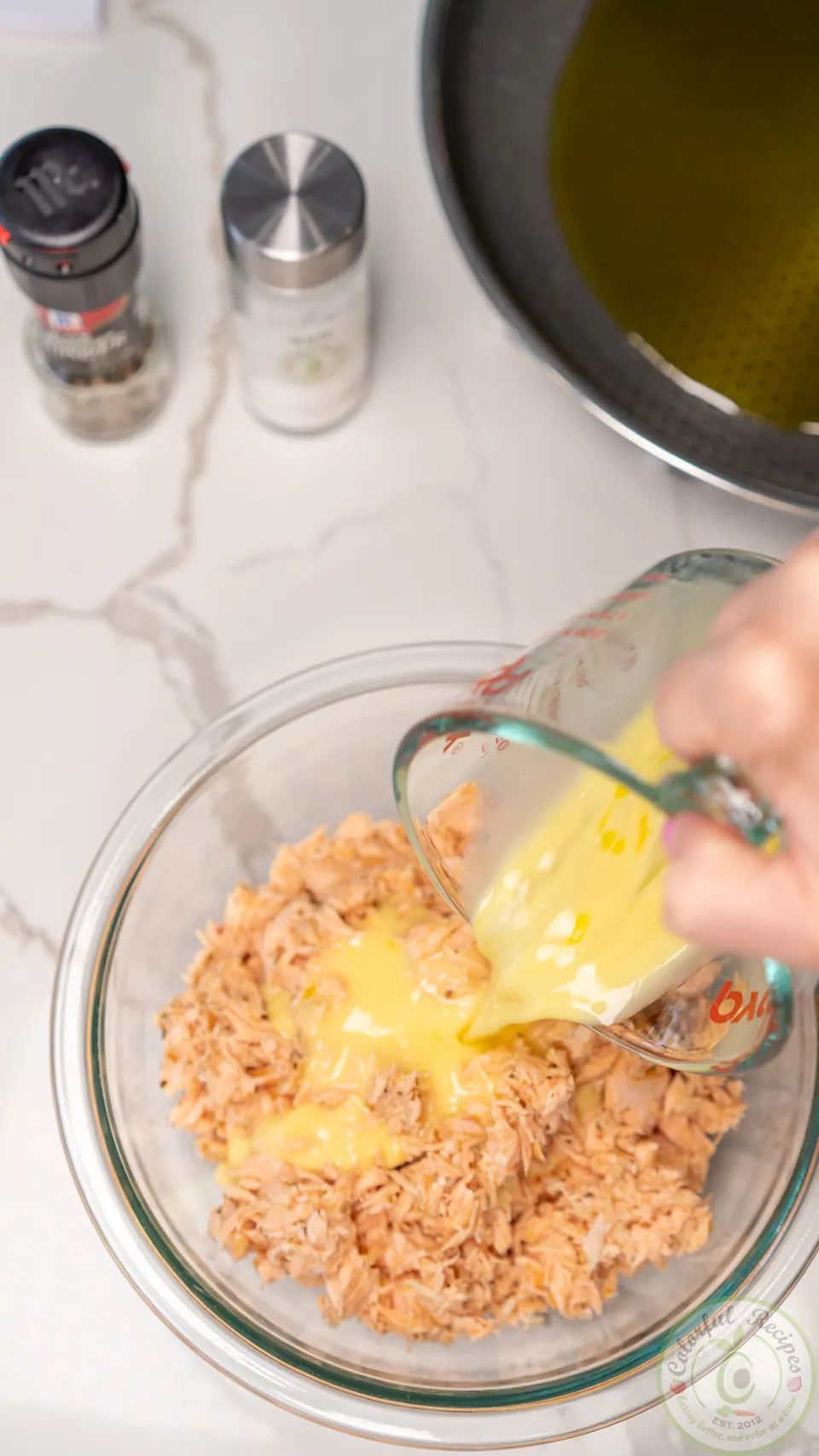 Adding egg mixture to salmon patty mix