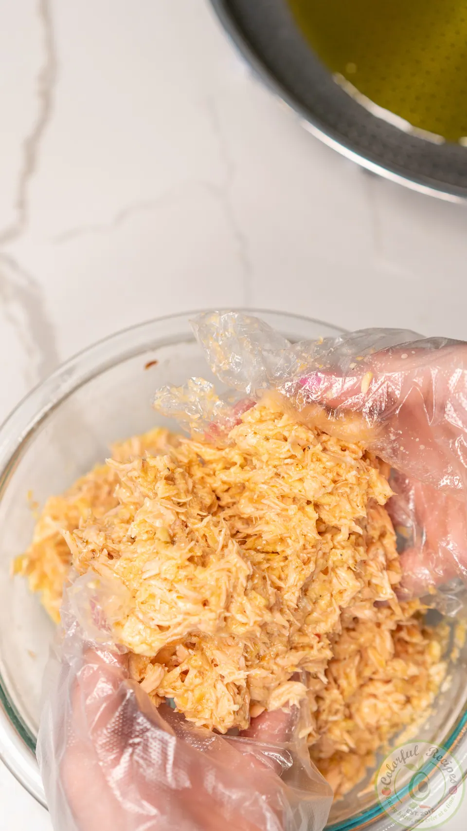 Mixing salmon patties by hand