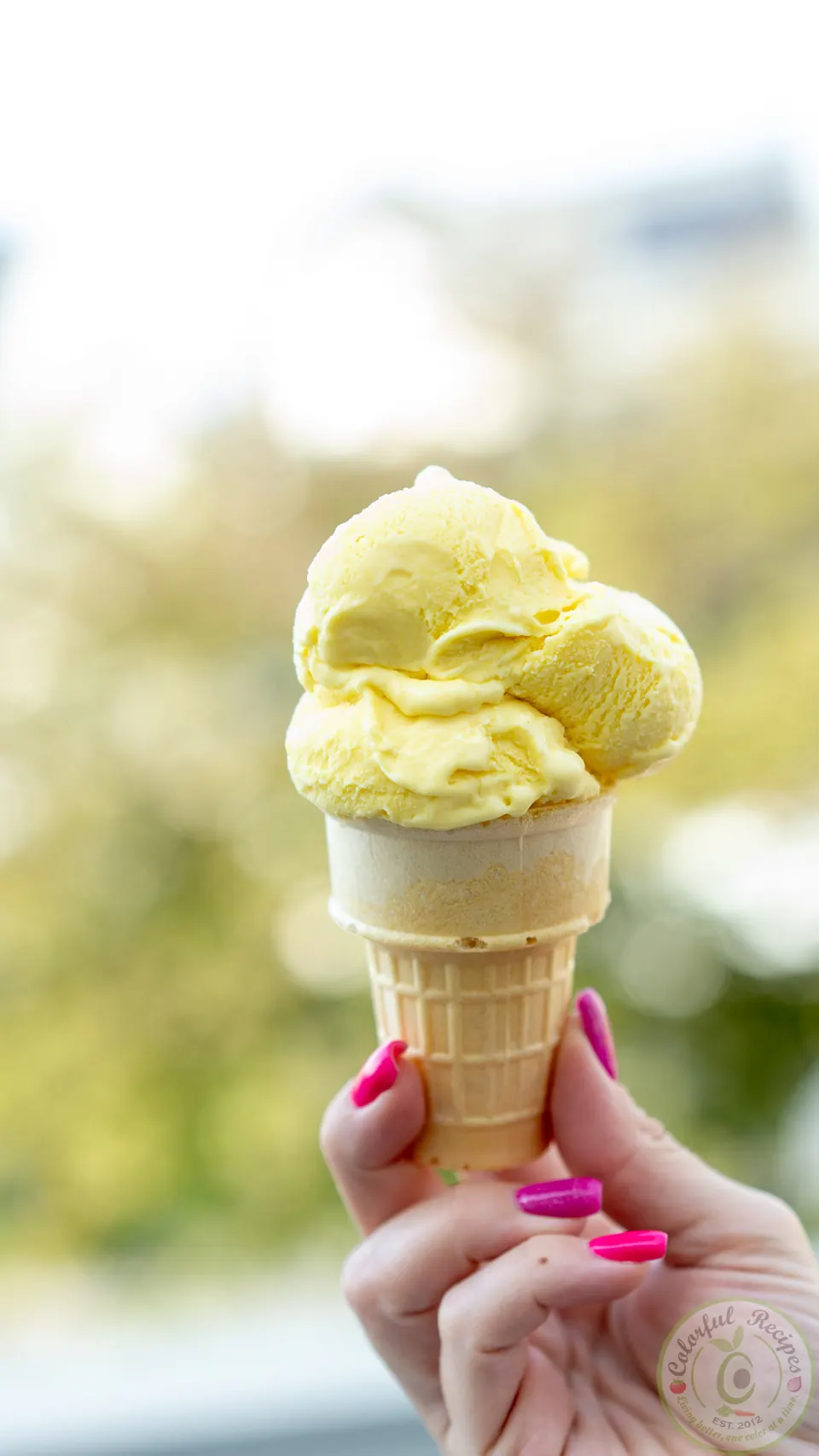 Golden spice turmeric ginger ice cream scooped into a cone