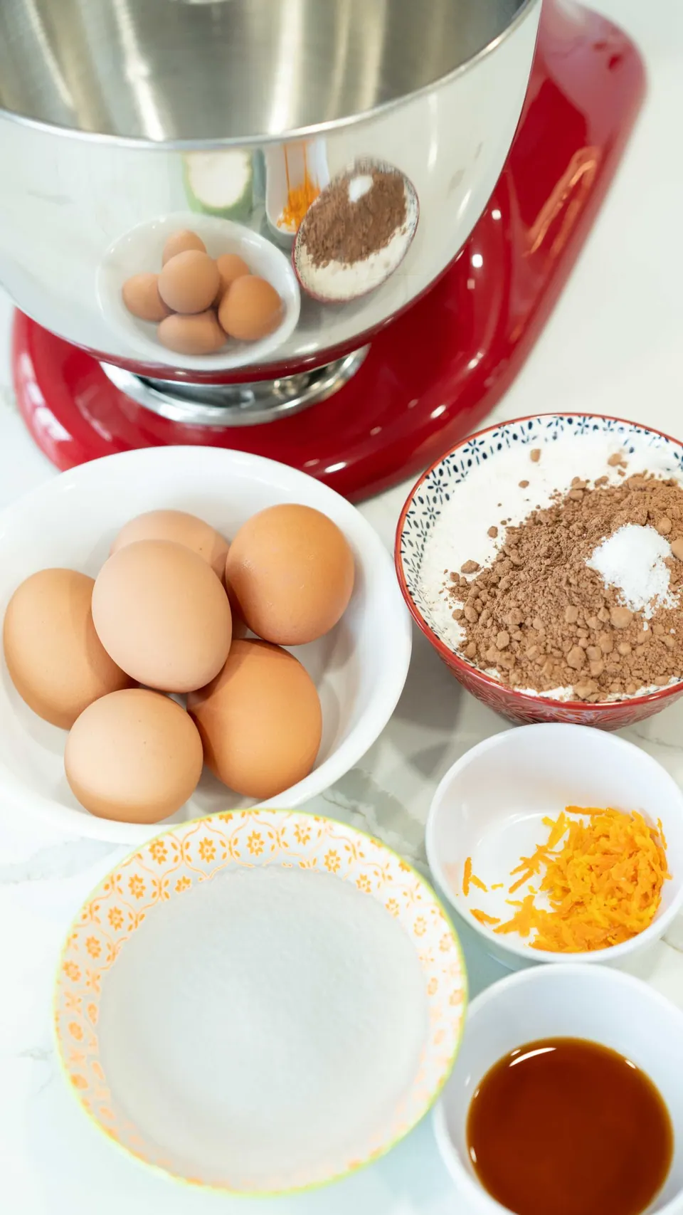 Ingredients for the Yule Log cake sponge set out next to a red stand mixer