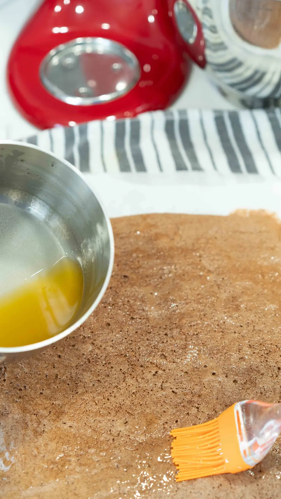 Brushing syrup over the chocolate sponge for the Yule Log cake