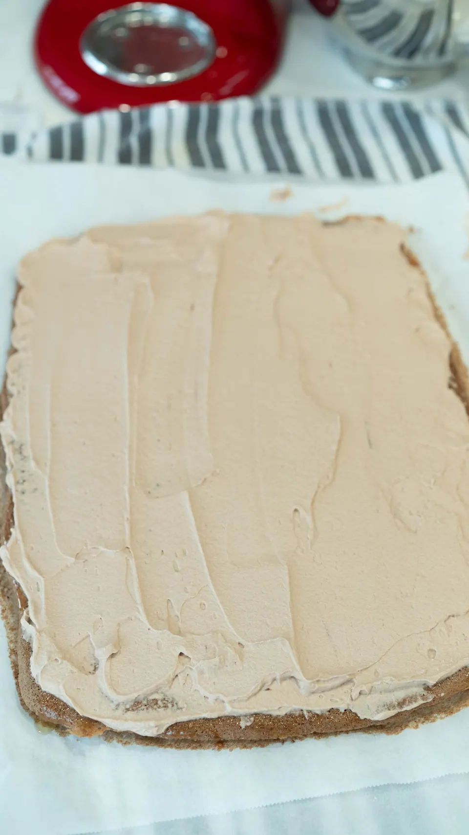 Yule Log sponge cake evenly covered with Nutella whipped cream filling