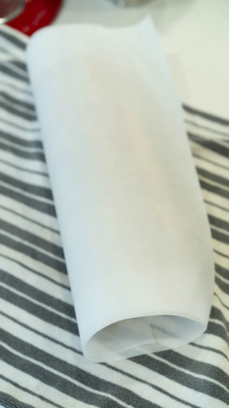 Rolled Yule Log cake wrapped in parchment paper