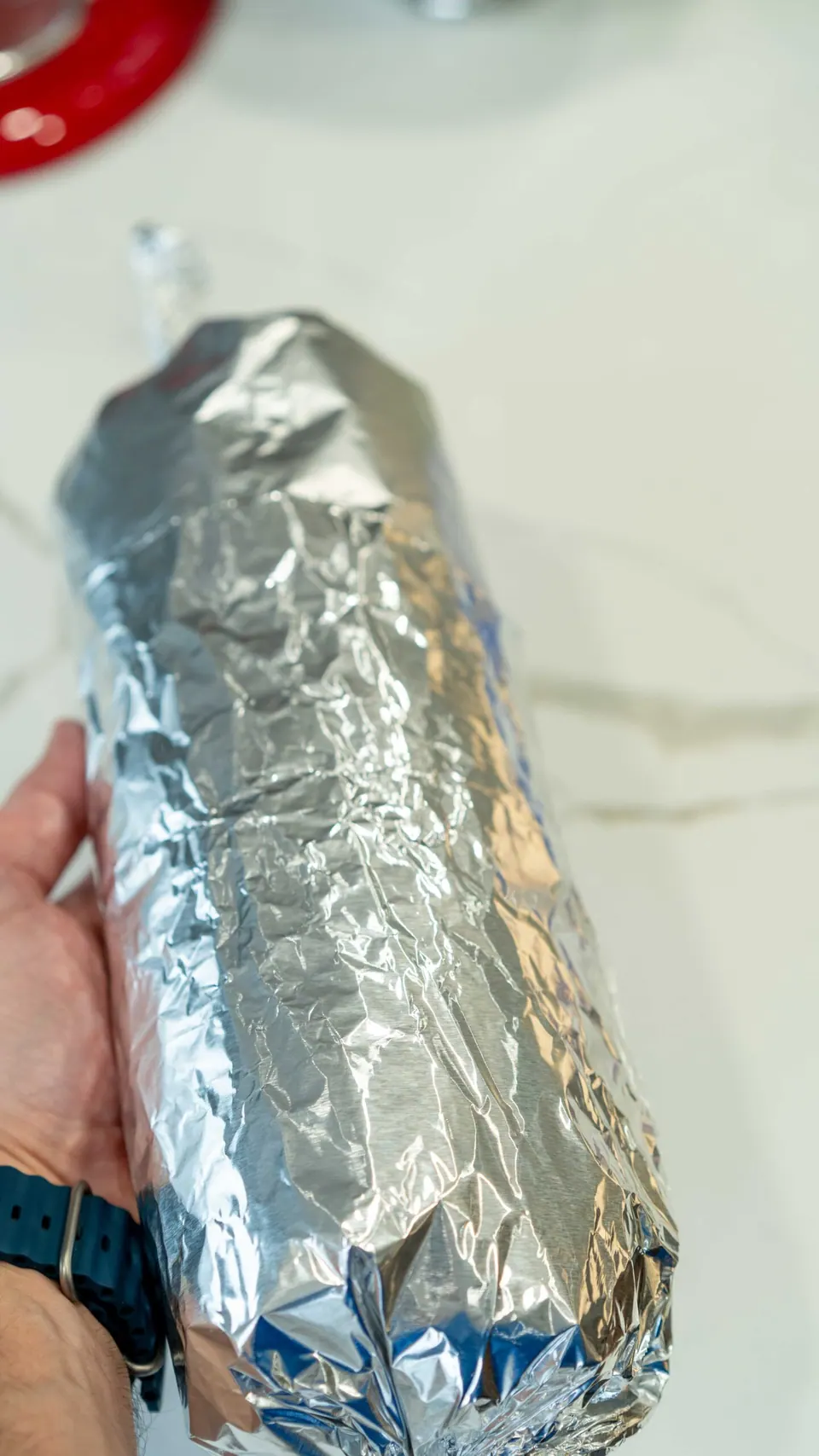 Foil-wrapped Yule Log cake ready for the freezer