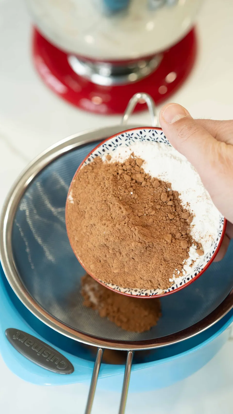 Sifting flour and cocoa powder for the chocolate Yule Log cake