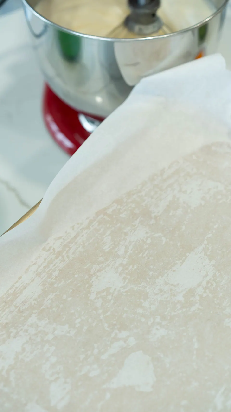 Half-sheet pan lined with parchment paper for the Yule Log cake