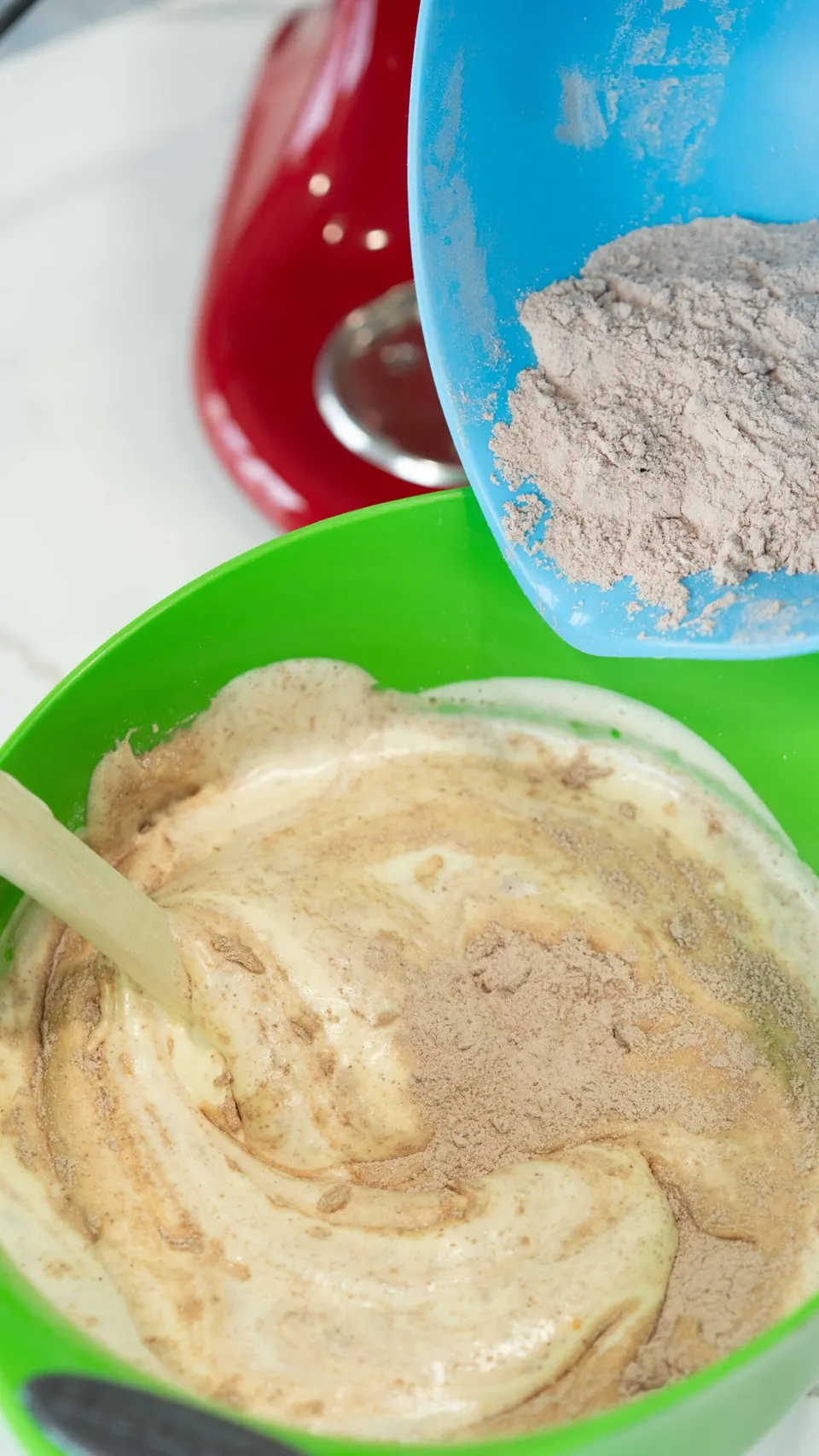 Folding the cocoa flour mixture into whipped eggs for Yule Log cake batter