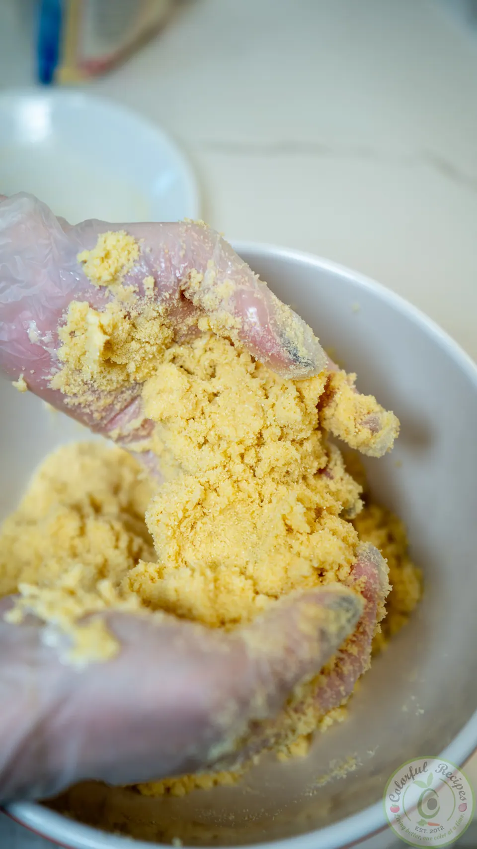 Working butter into semolina by hand for maamoul dough