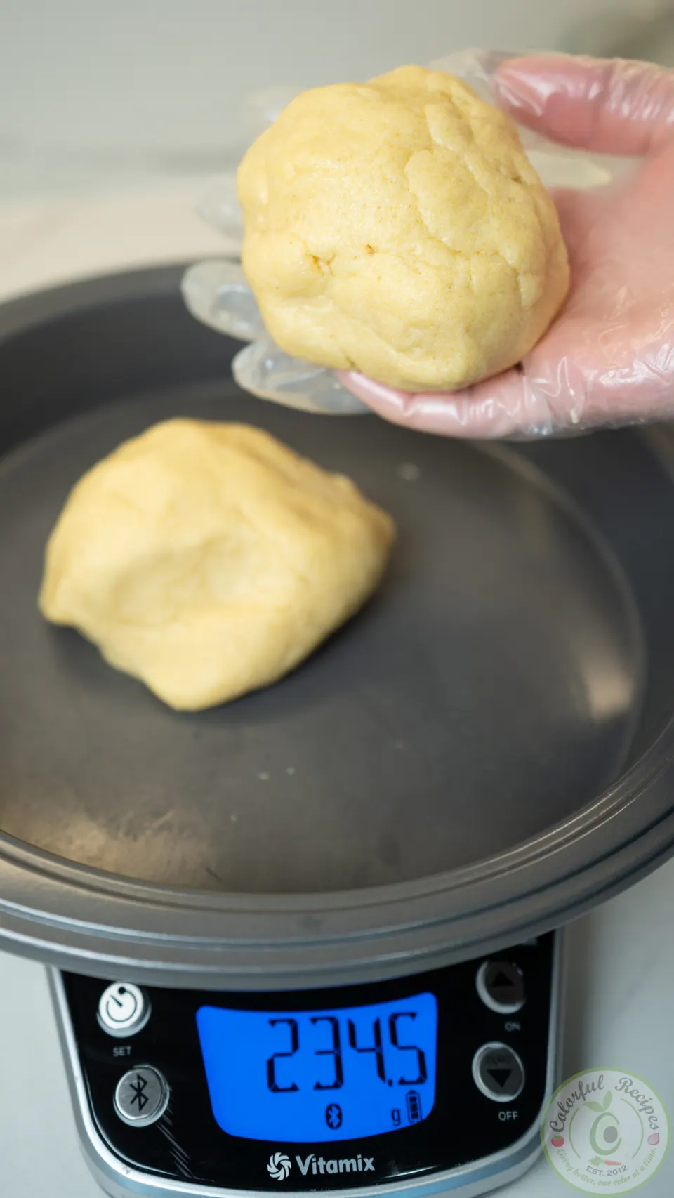 Weighing portions of maamoul dough on a kitchen scale