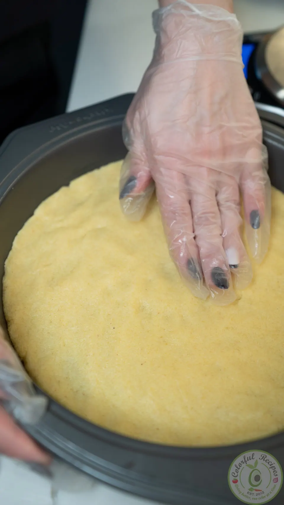 Pressing semolina dough into a round cake pan
