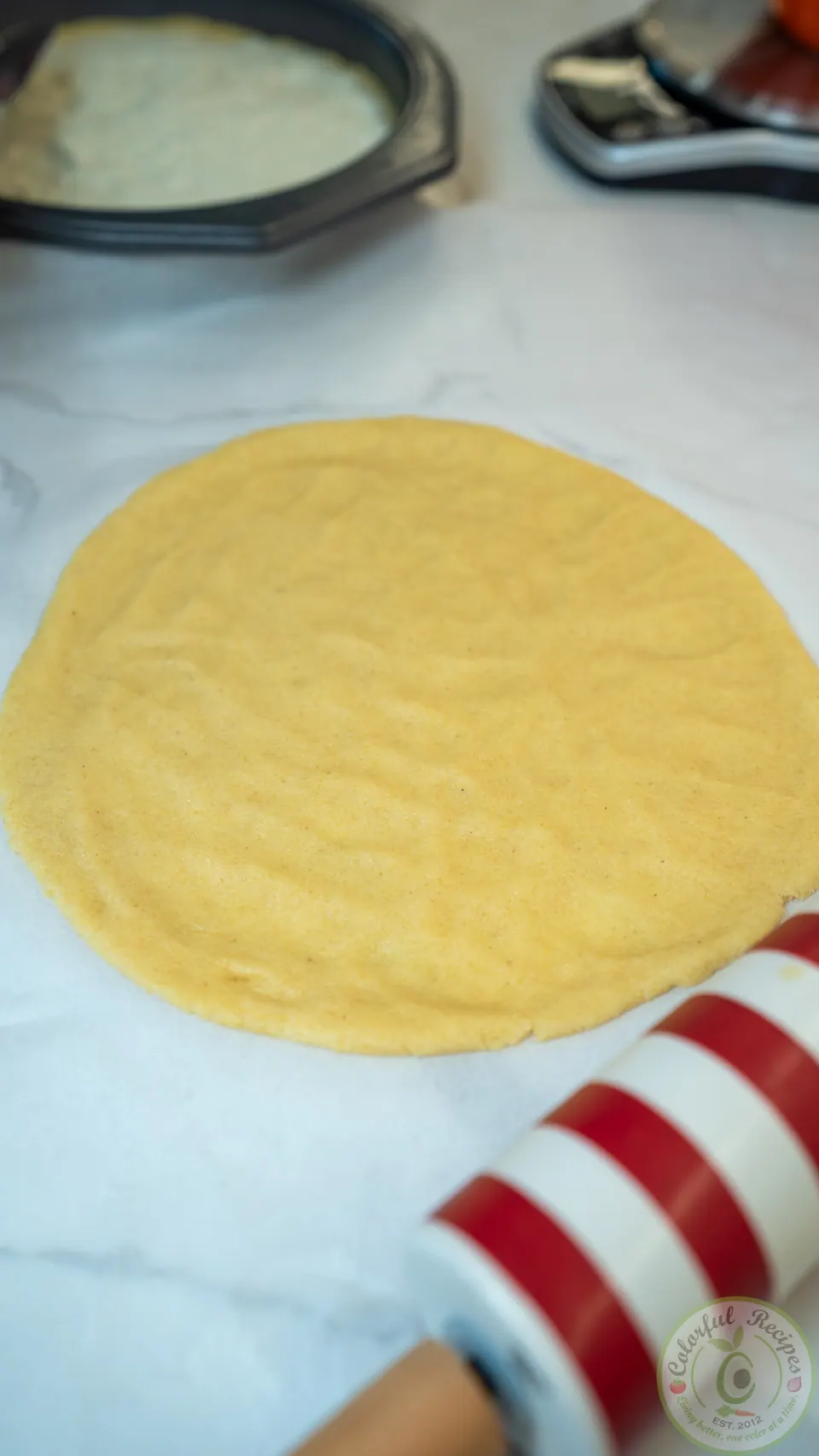 Rolled-out round of maamoul dough on parchment paper