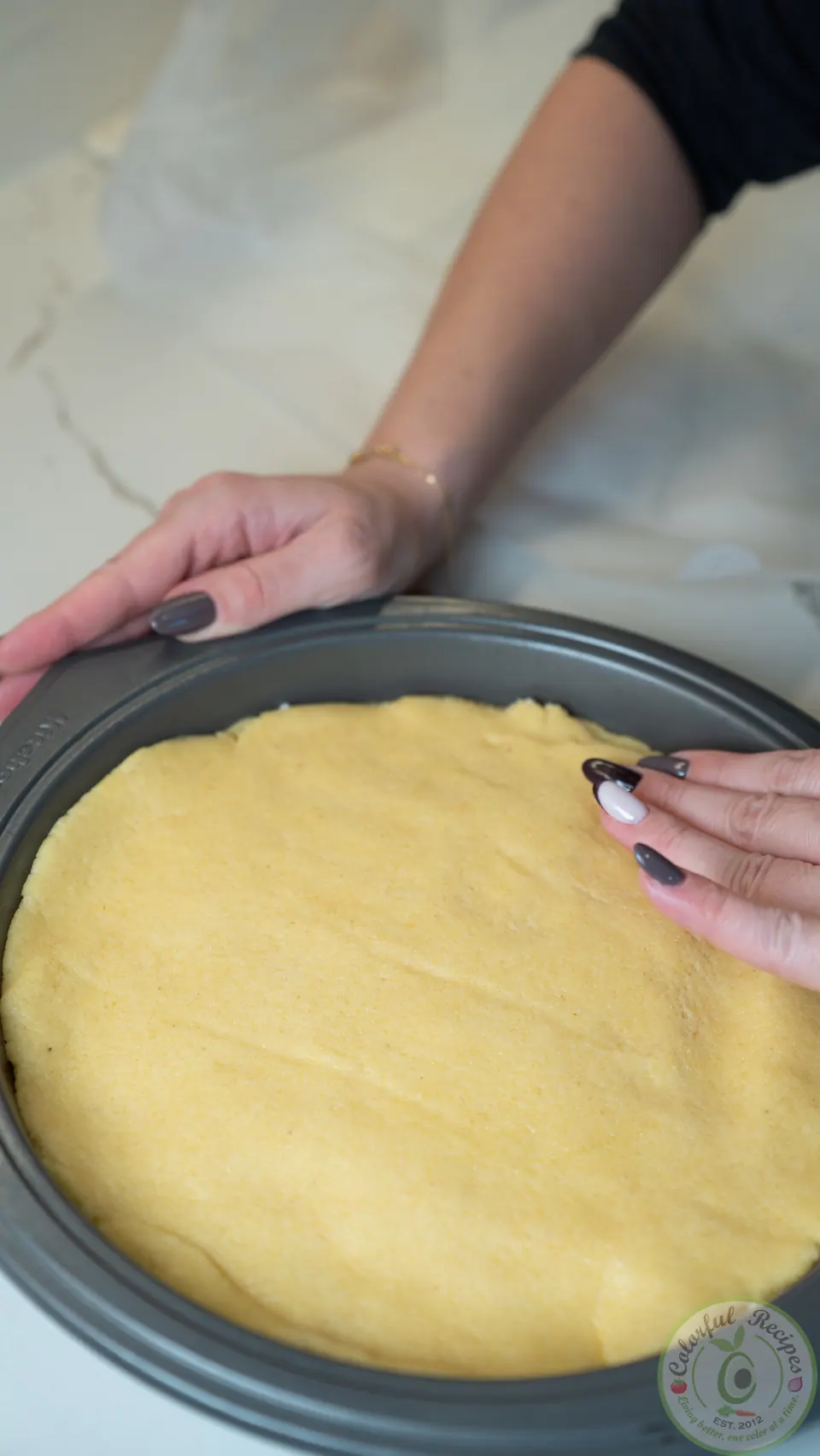 Sealing the edges of the top dough layer over the ashta filling