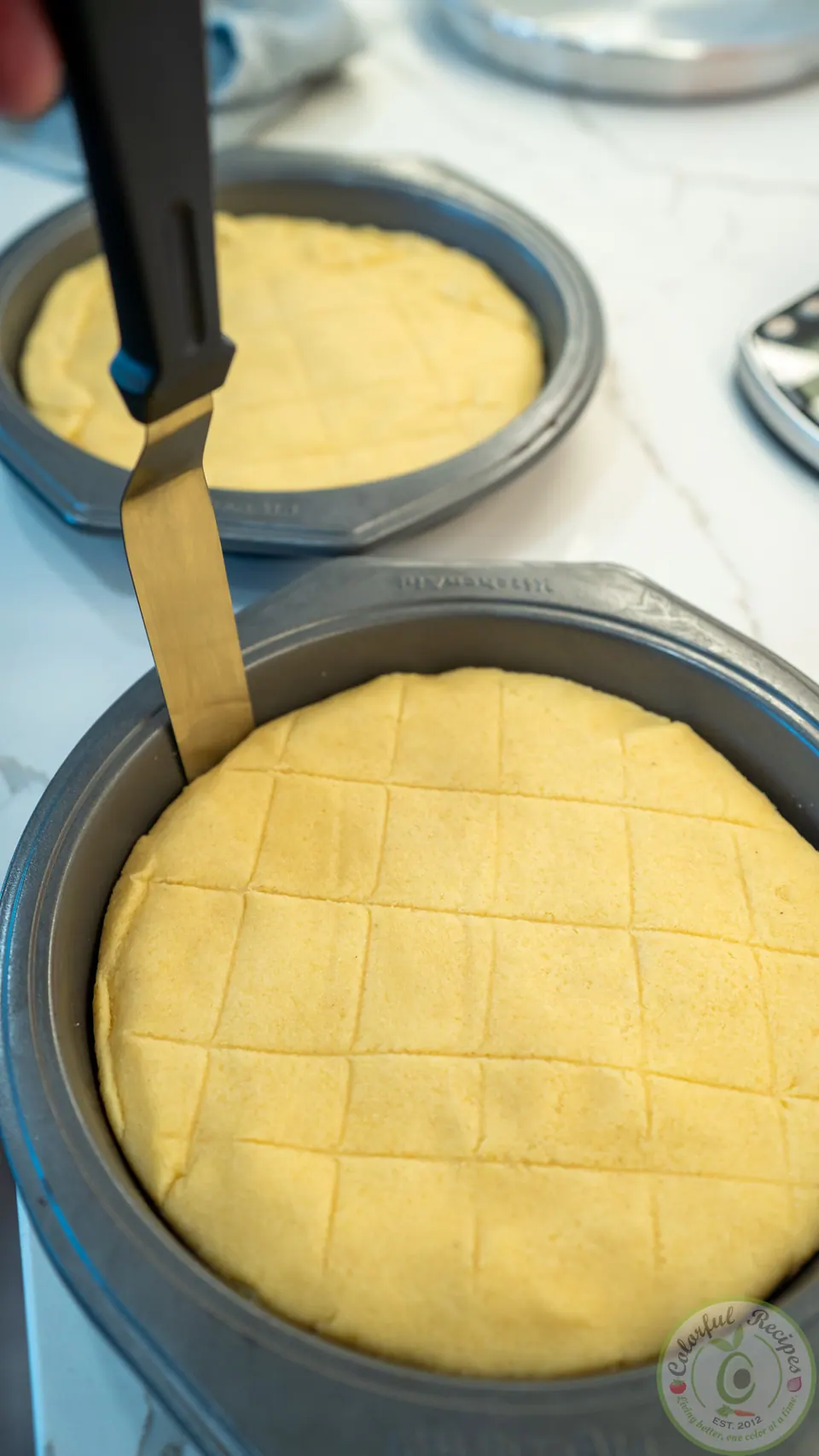 Scoring squares into the top of unbaked Maamoul Mad bi Ashta