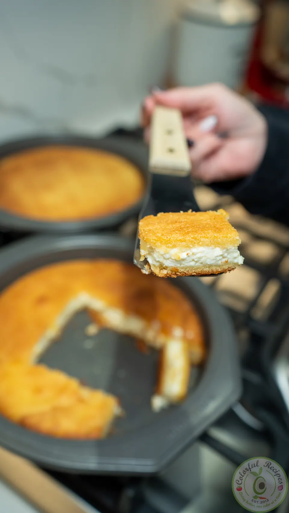 Lifting a square of Maamoul Mad bi Ashta out of the pan