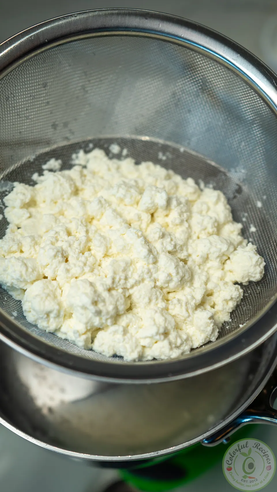 Strained clotted ashta in a sieve